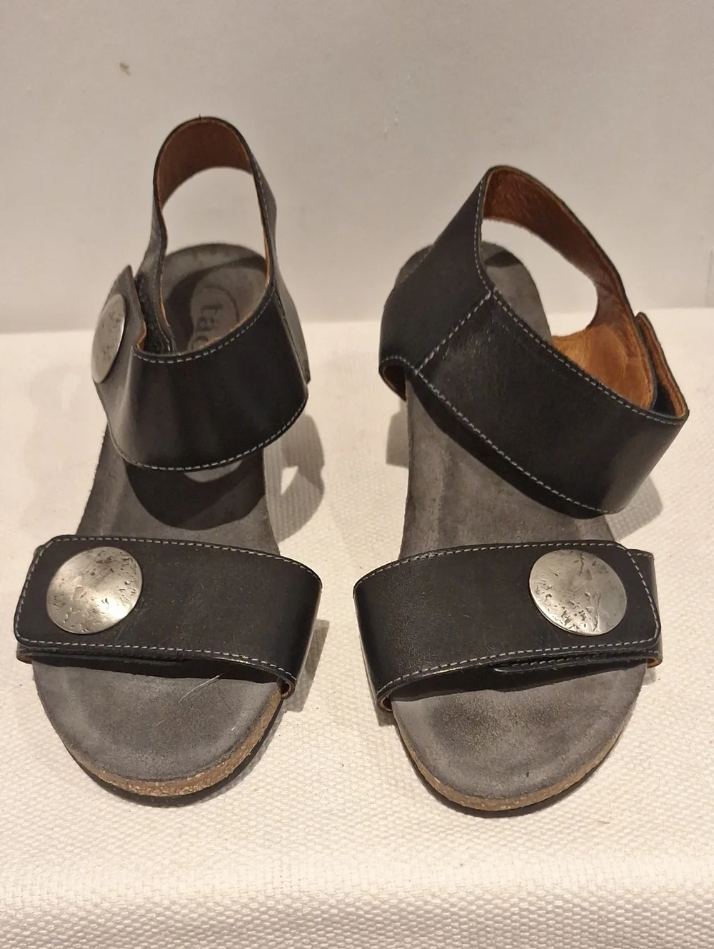 Taos Carousel 2 Black Leather Two-Strap Wedge Sandals With Silver Medalion